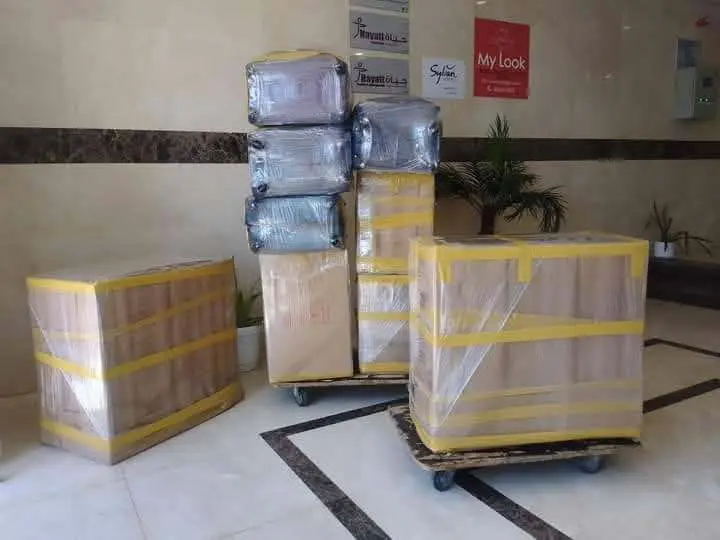 عربة نقل محملة بأغراض مغلفة داخل مبنى سكني